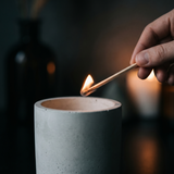 A long Terraeum match lighting a candle