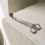 Terraeum matte stainless wick trimmer on concrete